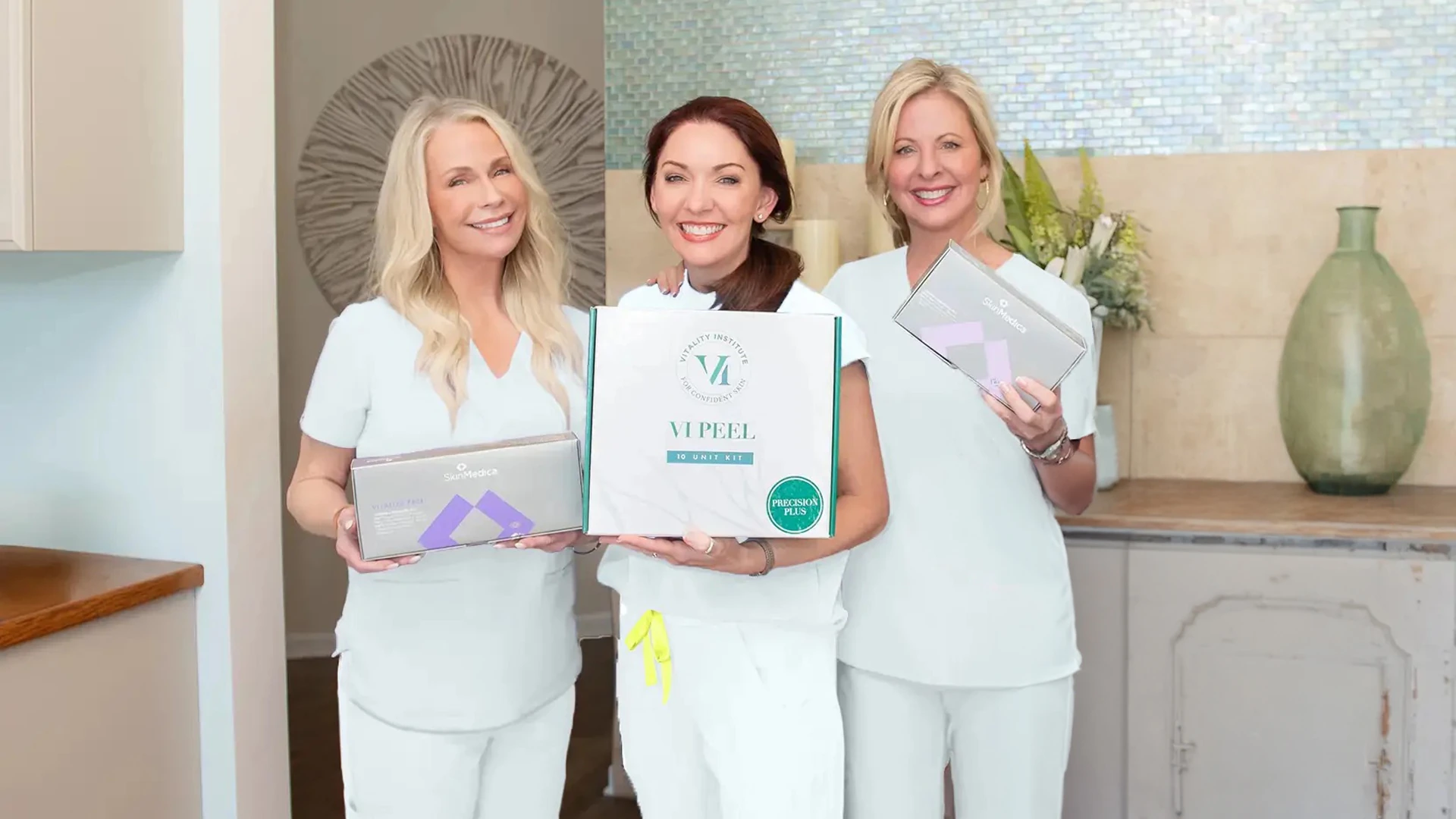 Wink staff in scrubs holding medical grade skincare products